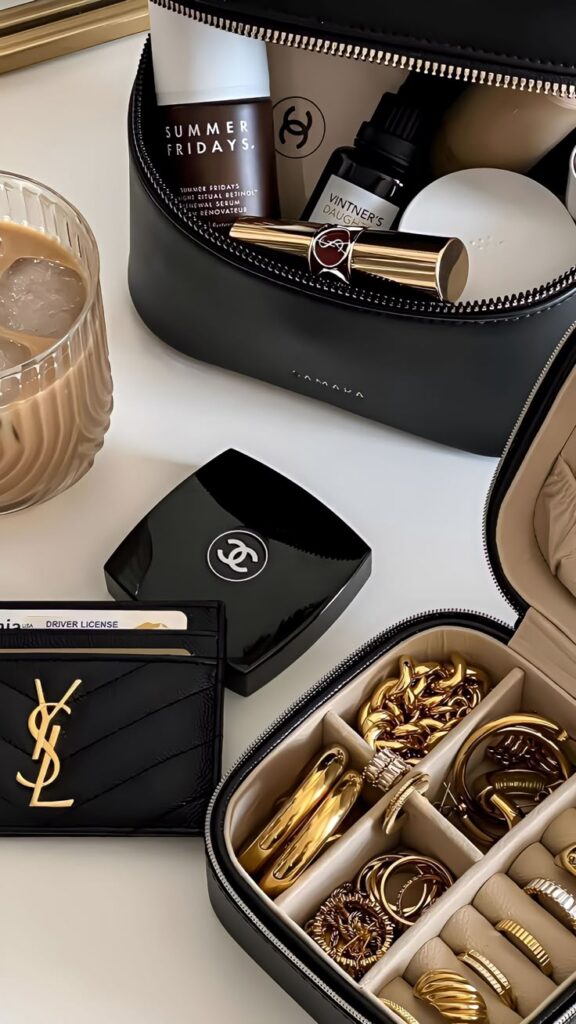 _ 18 Luxurious makeup and jewelry collection with skincare and accessories in sleek black cases on a stylish vanity setup. | Sky Rye Design Luxurious makeup and jewelry collection with skincare and accessories in sleek black cases on a stylish vanity setup.