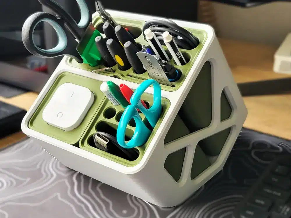 Modern desk organizer with scissors, pens, tools, and a smart device, ideal for office or home workspace organization.
