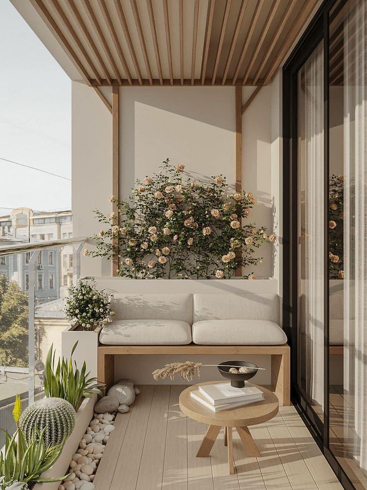Modern balcony with cozy seating, lush plants, and a wooden table, creating a serene outdoor retreat.