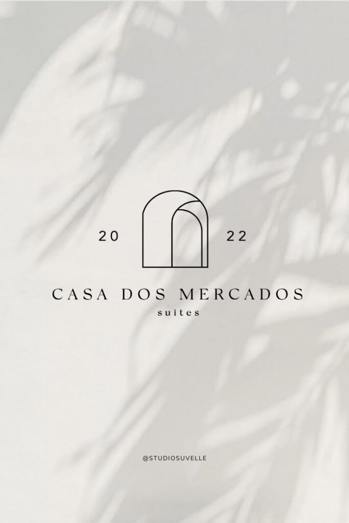 Casa Dos Mercados logo with arch design, 2022, Studio Suvelle branding on leaf shadow background.