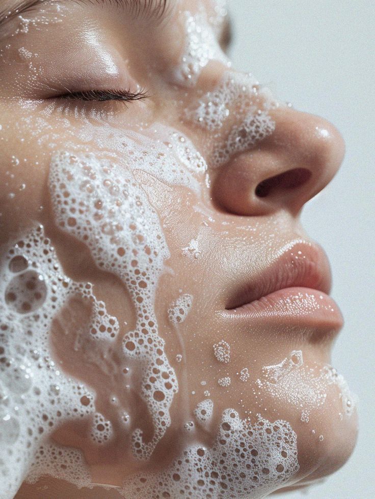 Close-up of a person with soap on their face, illustrating skincare routine and facial cleansing concept.