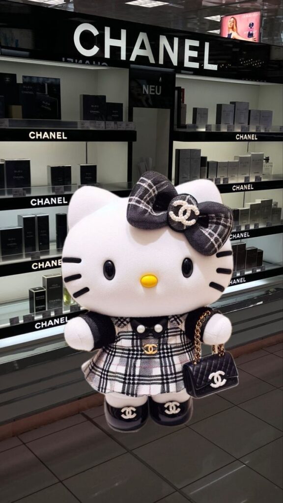 Hello Kitty in Chanel-themed outfit at a Chanel store, featuring a plaid dress, bow, and handbag.