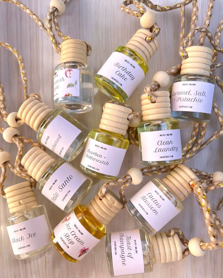 Assorted scented car diffusers with hanging ropes, featuring labels like Birthday Cake and Clean Laundry.