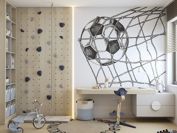 Kids' room with climbing wall, soccer mural, tricycle, and study desk. Perfect for active play and learning.