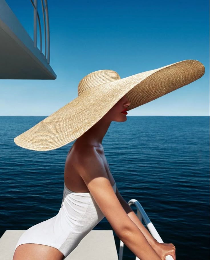 _ 3 Woman in white swimsuit with wide-brimmed straw hat on yacht deck by the sea under blue sky. | Sky Rye Design Woman in white swimsuit with wide-brimmed straw hat on yacht deck by the sea under blue sky.
