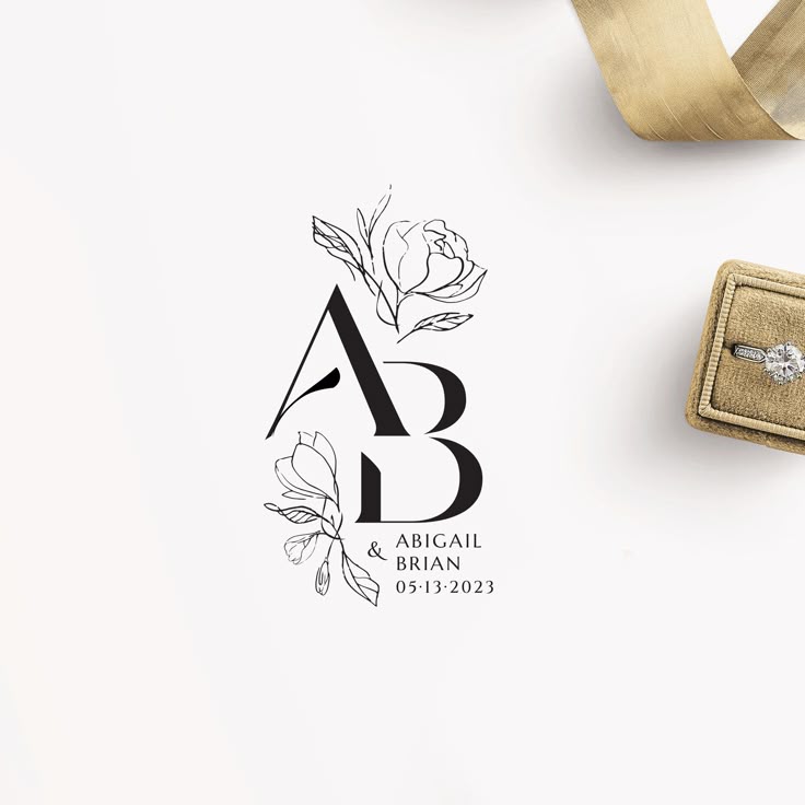 Elegant monogram with floral design next to an engagement ring in box, featuring A & B and wedding date 05-13-2023.