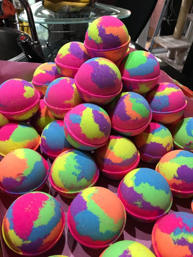35e9382d94d9f496fdf9829044708fb0 Vibrant rainbow-colored bath bombs stacked in a pyramid shape, adding a splash of color to a bathroom display. | Sky Rye Design Vibrant rainbow-colored bath bombs stacked in a pyramid shape, adding a splash of color to a bathroom display.