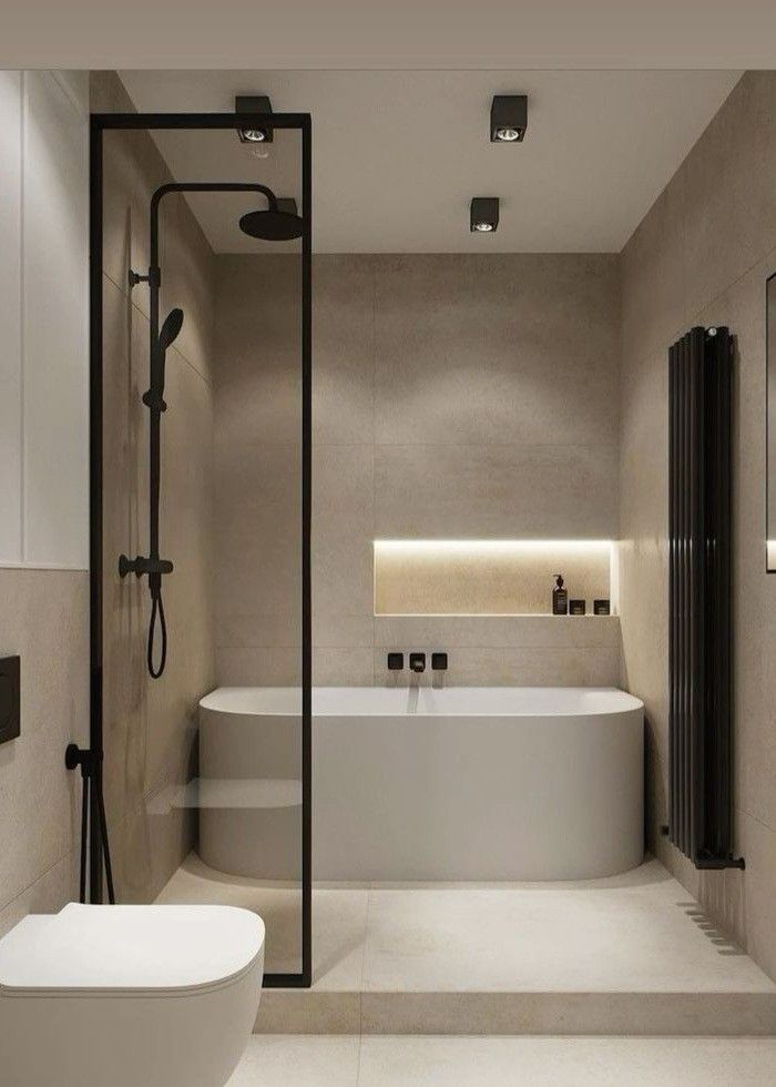 Modern bathroom with a sleek tub, glass shower partition, recessed lighting, and minimalist decor. Clean, elegant design.