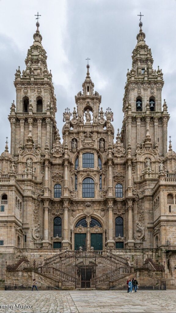 Baroque facade of the Cathedral of Santiago de Compostela, Spain, featuring ornate architecture and twin towers.