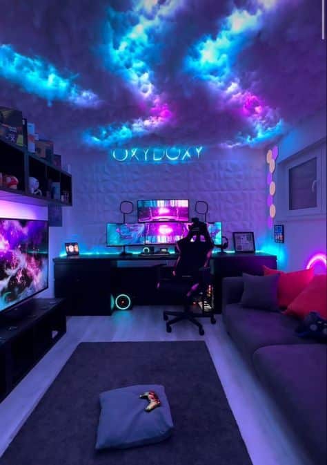 _ 4 Futuristic gaming room with neon lighting, dual monitors, gaming chair, and ambient cloud ceiling lights. | Sky Rye Design Futuristic gaming room with neon lighting, dual monitors, gaming chair, and ambient cloud ceiling lights.