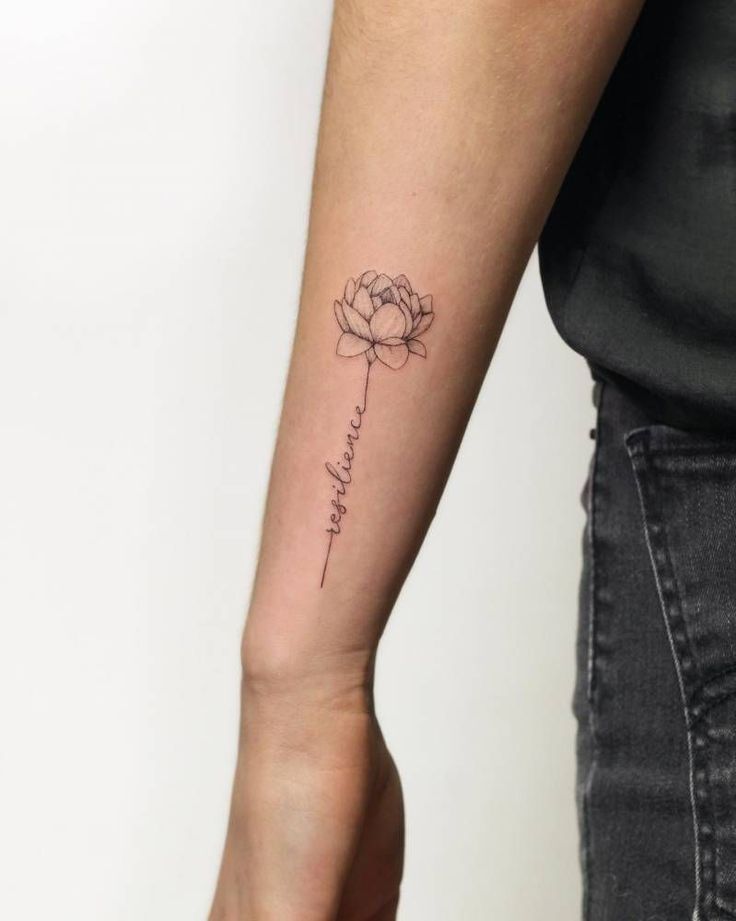 Minimalist flower tattoo on forearm with the word resilience in script, symbolizing strength and growth.