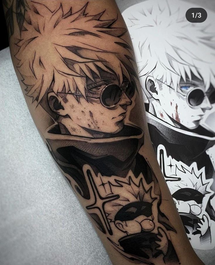 Anime-inspired tattoo with spiky hair and sunglasses, detailed blackwork design on arm, next to printed artwork.