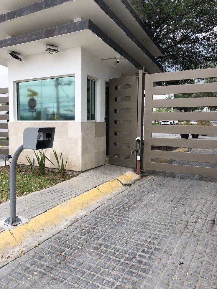 _ 47 Security gate entrance with keypad and guard booth under modern roof design. | Sky Rye Design Security gate entrance with keypad and guard booth under modern roof design.