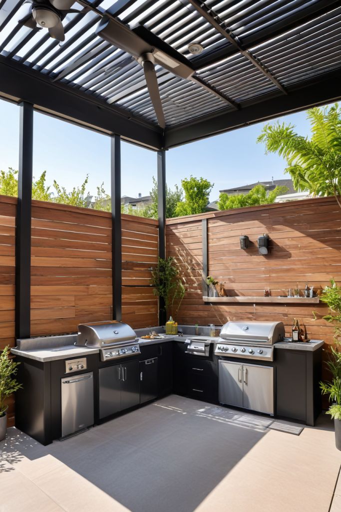 Modern outdoor kitchen with stainless steel grills, under a pergola with wooden accents and green plants.