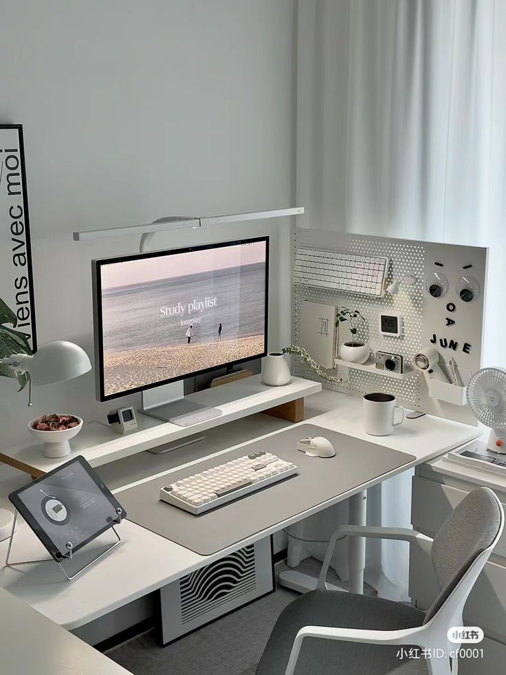4fe8b867-dfff-4776-99e1-a1ef7423f49c Minimalist home office setup with monitor, keyboard, gray chair, and greenery for a modern study environment. | Sky Rye Design Minimalist home office setup with monitor, keyboard, gray chair, and greenery for a modern study environment.