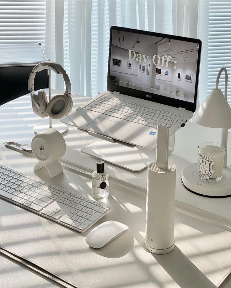 Minimalist workspace with laptop, headphones, and accessories. Sunlit desk setup for a relaxing day off.