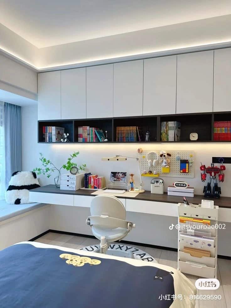 Modern bedroom with study desk, books, and toys, featuring a cozy bed and storage cart under soft lighting.