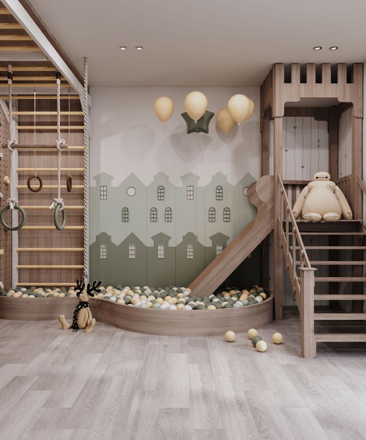 Children's indoor playroom with climbing wall, slide, and ball pit, featuring pastel decor and wooden elements.