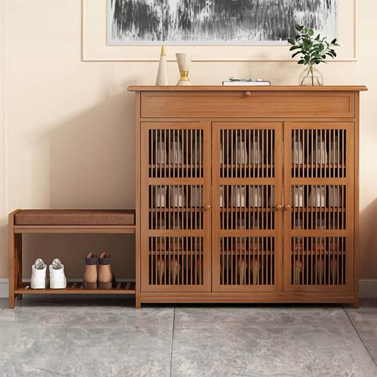 Wooden shoe cabinet with seating bench and decor, ideal for stylish and organized entryway storage.