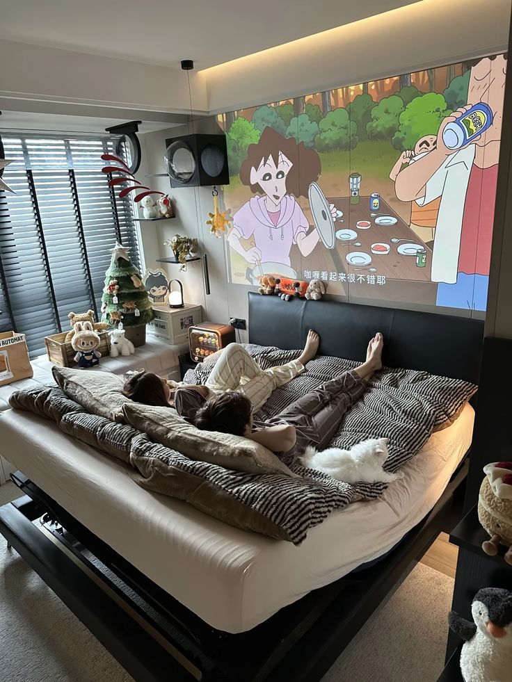 Couple relaxing in a cozy bedroom watching anime on a projector screen, with a festive decor and plush toys nearby.