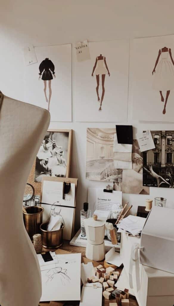 Fashion design studio with sketches, fabric swatches, and a mannequin, showcasing creative workspace elements.