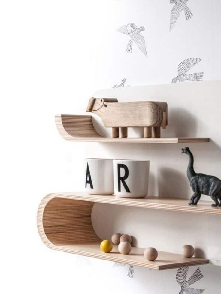 Modern wooden shelves with playful animal toys and lettered cups add a whimsical touch to a stylish room decor.