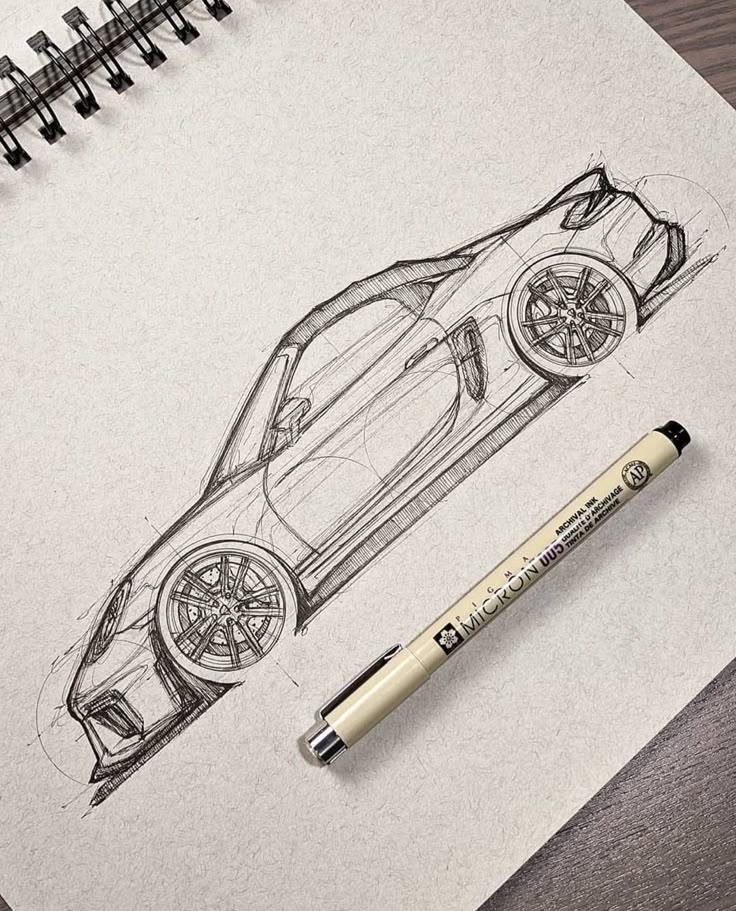 Pencil sketch of a sports car on paper with a Micron pen beside it, detailed automotive design blueprint.