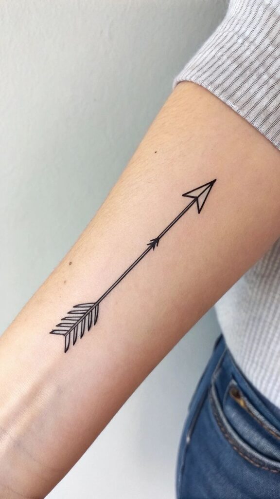 Minimalist arrow tattoo on forearm showcasing simplicity and style. Perfect body art inspiration.