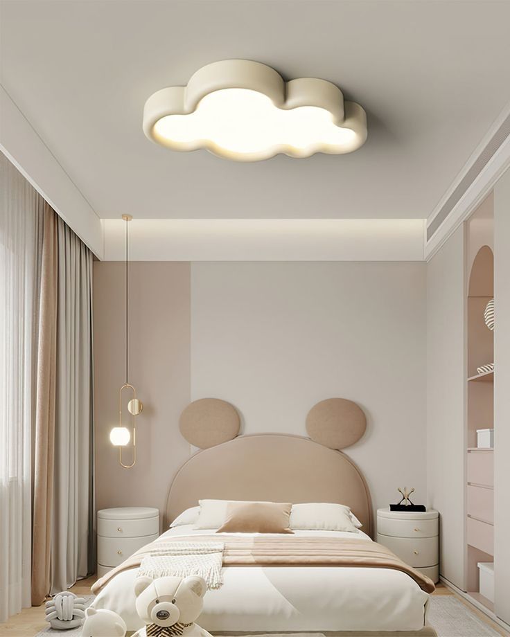 Modern kids' bedroom with cloud ceiling light, pastel decor, and teddy bear-themed design elements for a cozy ambiance.