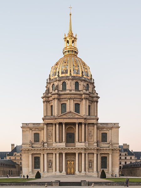Exterior view of Les Invalides with its iconic golden dome under a clear sky, Paris landmarks.
