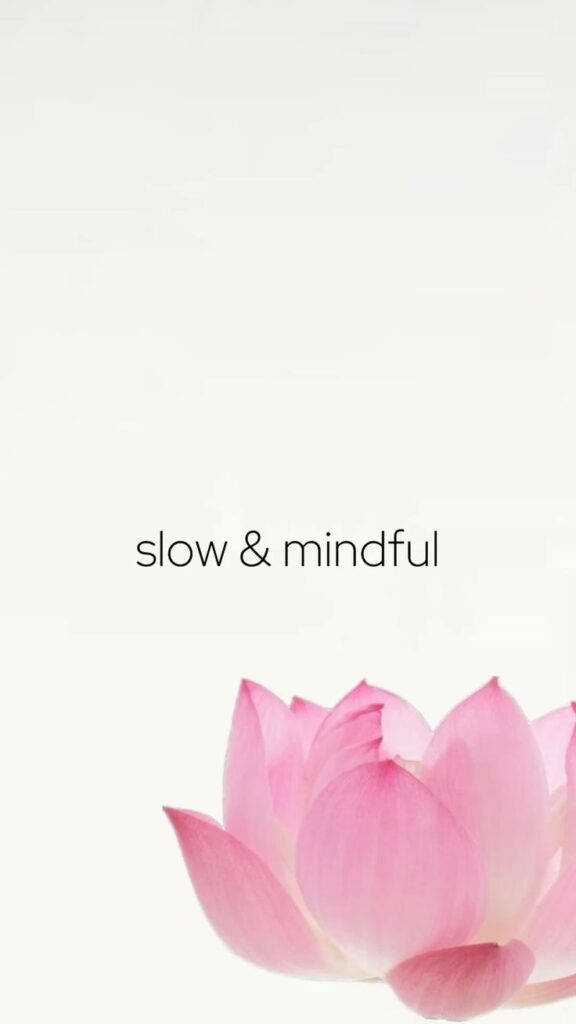 Pink lotus flower with slow & mindful text on a white background, symbolizing tranquility and mindfulness.