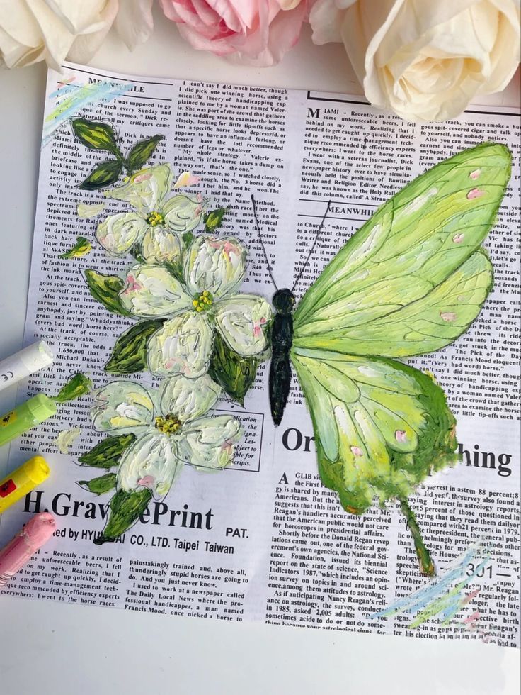 Green butterfly and white flowers painted on newspaper background with pastel crayons on the side.