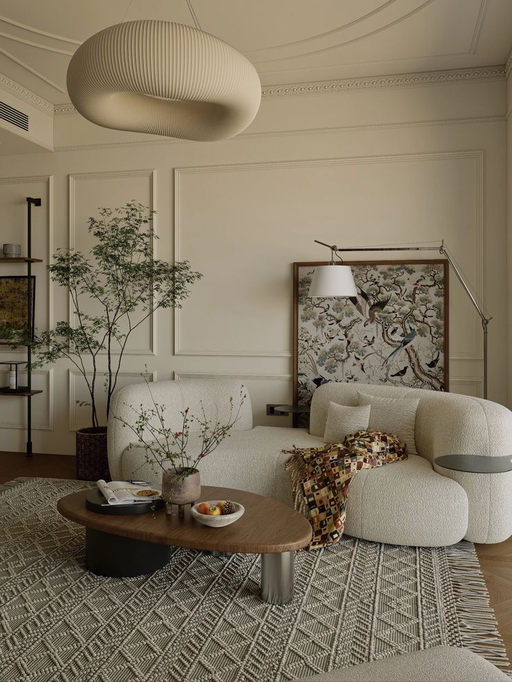 Modern living room with white sofa, abstract lighting, coffee table, and artistic wall decor. Cozy and elegant design.