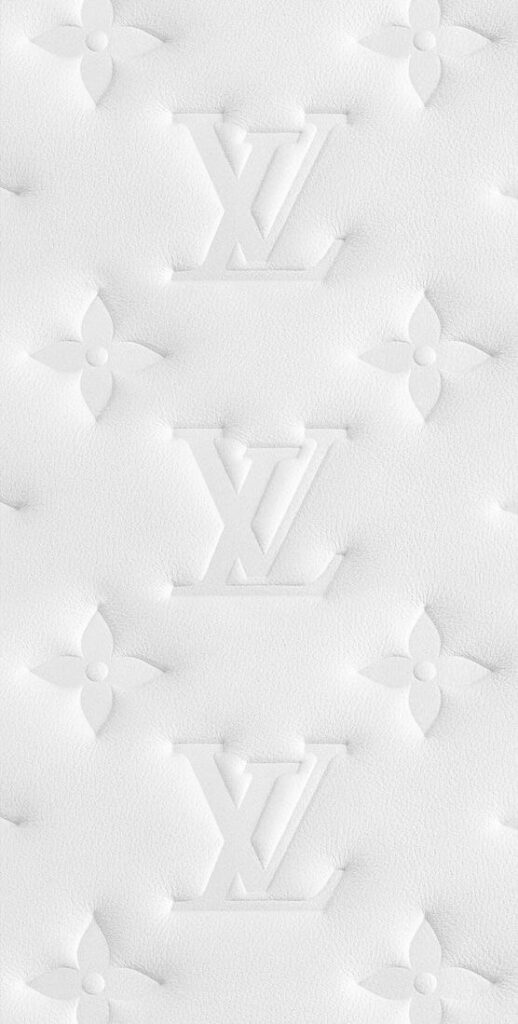 Embossed white leather pattern with floral motifs and initials on a luxury design background.