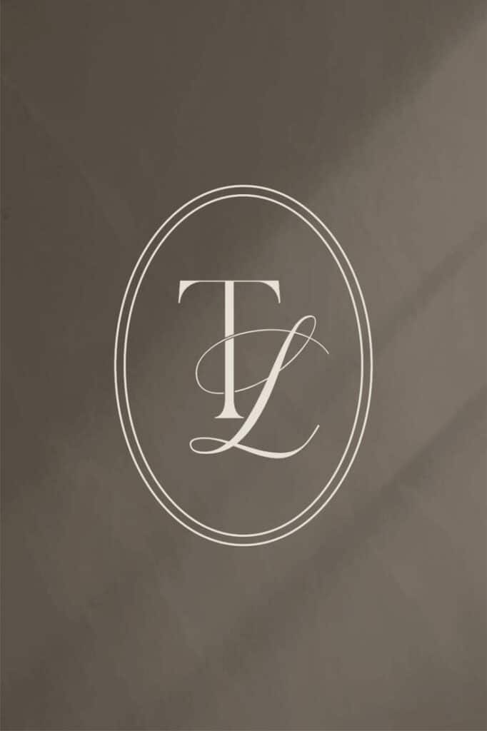 Elegant logo with TL letters in a circle on a textured gray background.