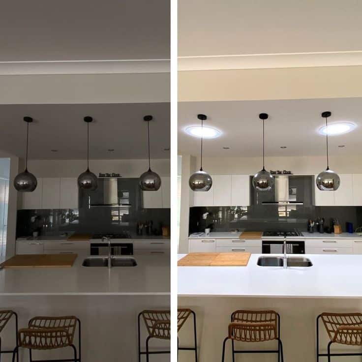 Modern kitchen with pendant lights, showing before and after lighting transformation for brighter illumination.