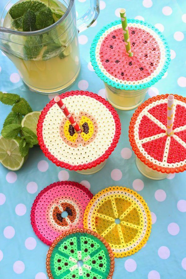Colorful bead fruit coasters and lemonade on a polka dot tablecloth with fresh mint and lime slices.