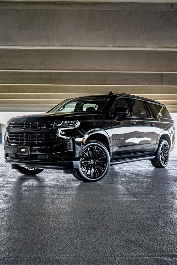 Blackout Chevy Suburban Black luxury SUV parked in a modern garage with sleek design and polished finish. | Sky Rye Design Black luxury SUV parked in a modern garage with sleek design and polished finish.