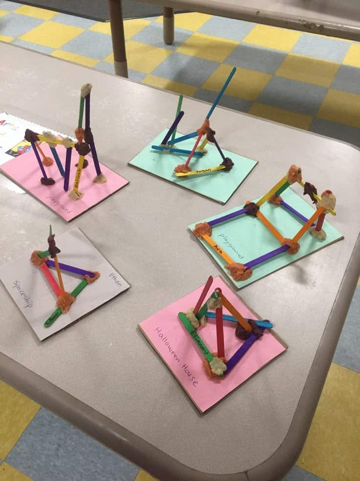 Children's craft project using colored straws and clay on construction paper, labeled with creative names.