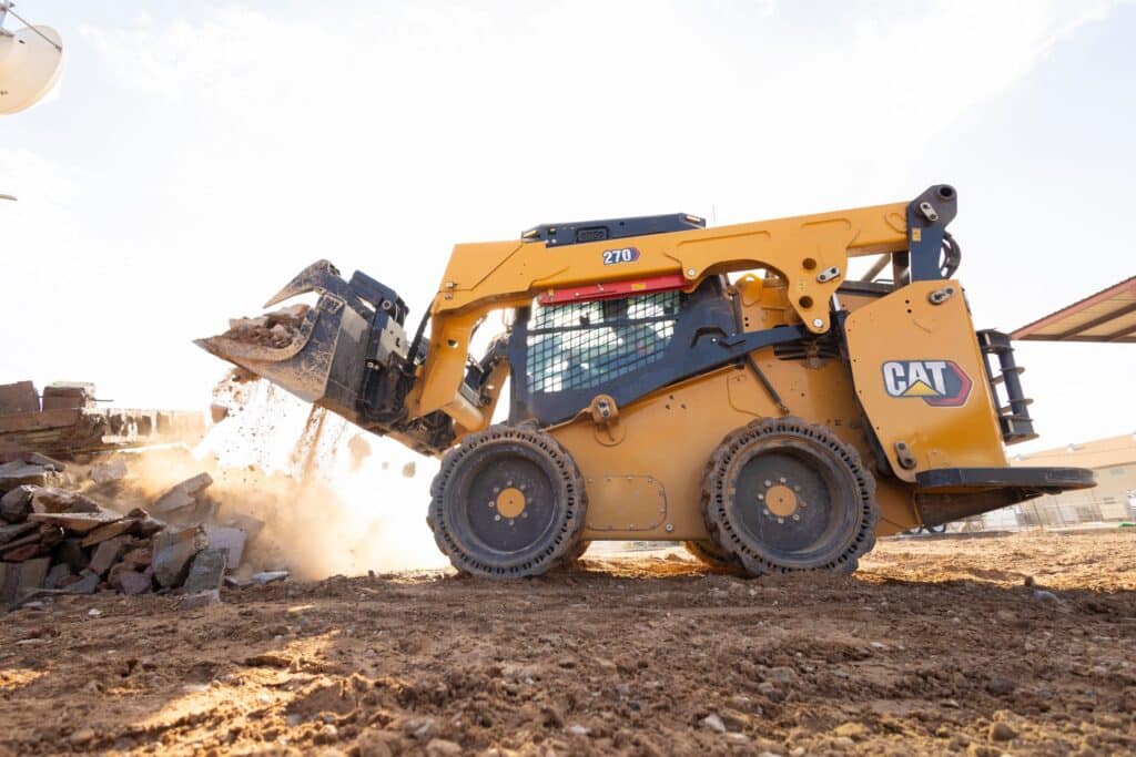 CM20240821-c4e16-4164d Yellow skid steer loader moving dirt on construction site in the daytime. | Sky Rye Design Yellow skid steer loader moving dirt on construction site in the daytime.
