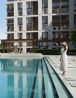 COMMUNITY_FEATURED_320X415 Woman in white dress by modern apartment pool on a sunny day. | Sky Rye Design Woman in white dress by modern apartment pool on a sunny day.