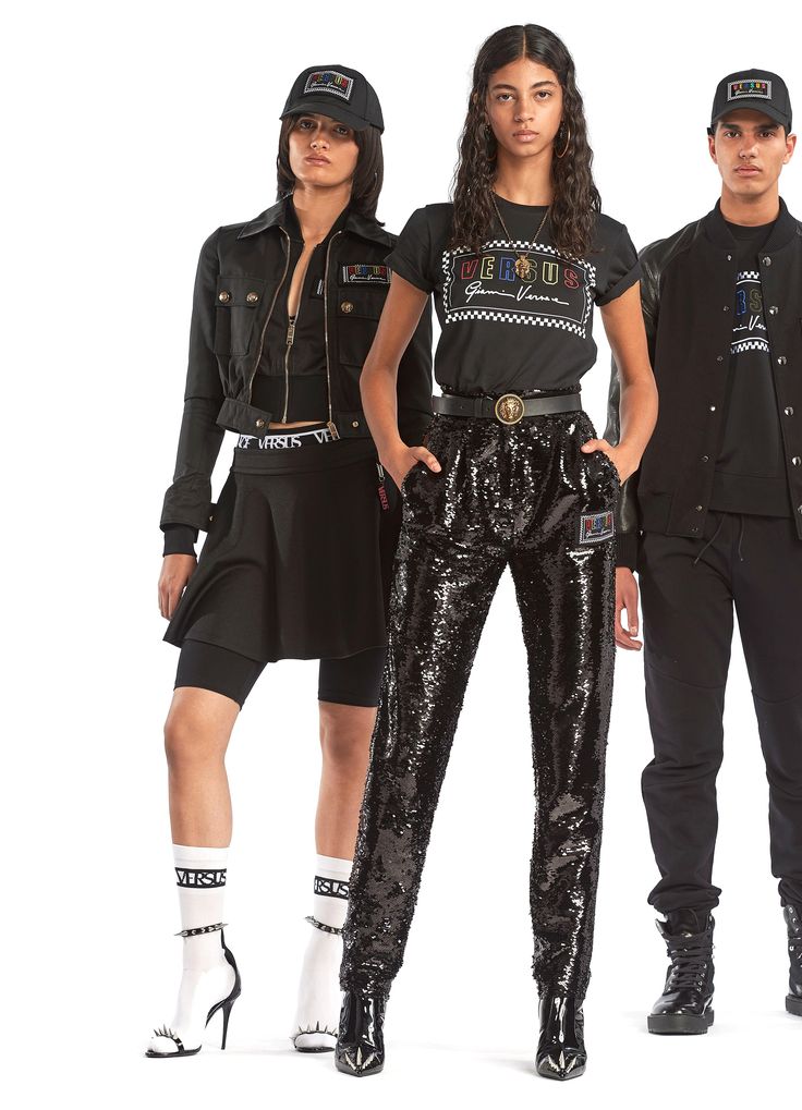 Three models showcasing stylish black Versus Versace outfits, including sequined pants and branded caps.