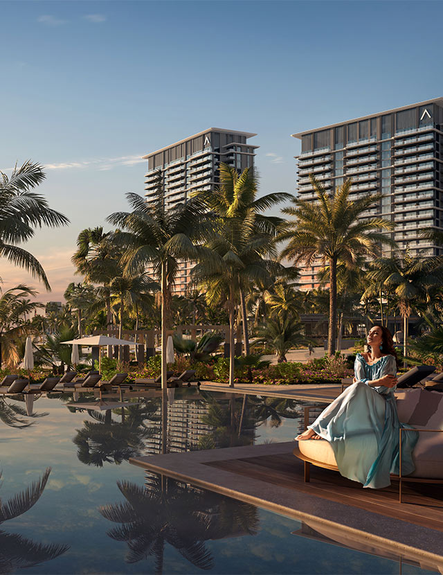 Luxurious resort with palm trees, pool reflections, and modern high-rise buildings in the background at sunset.