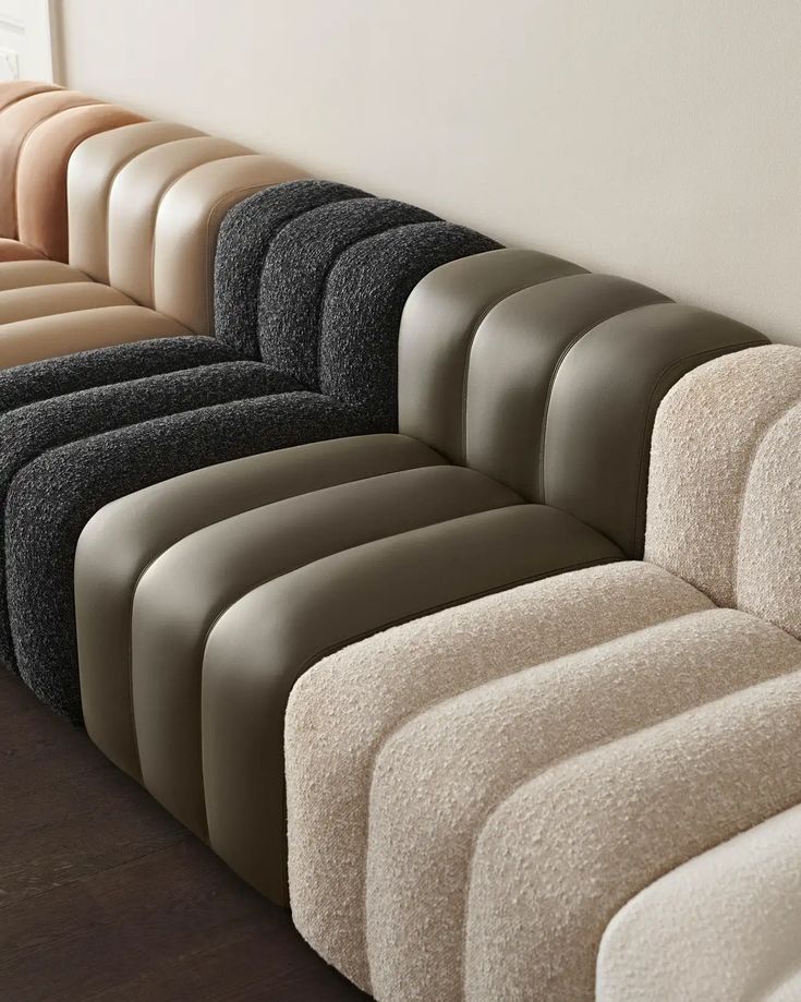 Modern modular sofa with curved design and various neutral colors for contemporary living spaces.