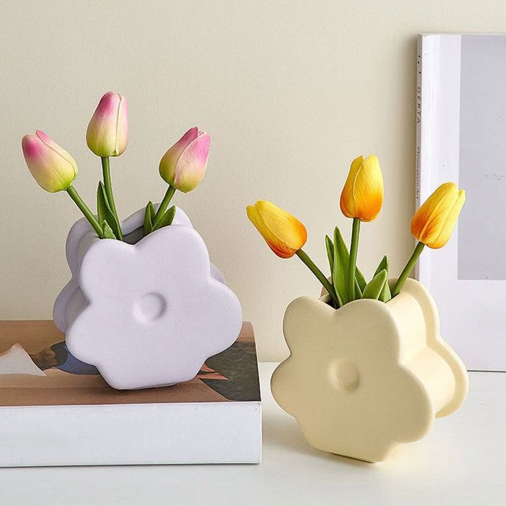 Flower-shaped vases with tulips decorate a tabletop, adding a touch of spring elegance to the room.