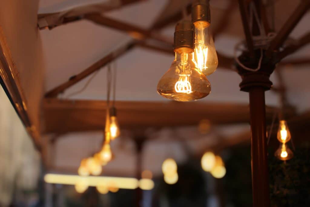 Warm glowing vintage light bulbs hanging under a canopy, creating a cozy ambiance.