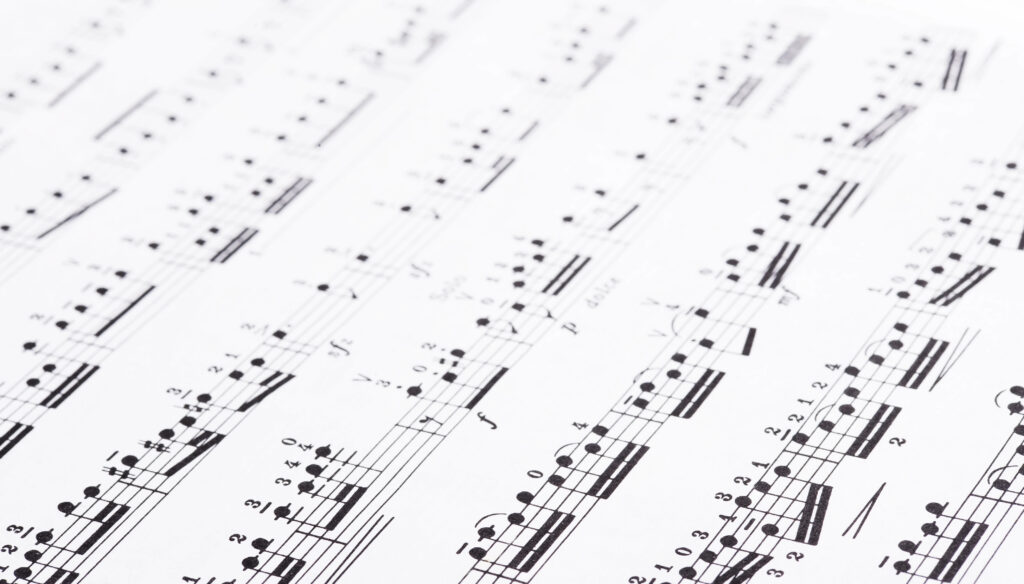 Close-up of sheet music with musical notes and notations on a white background.
