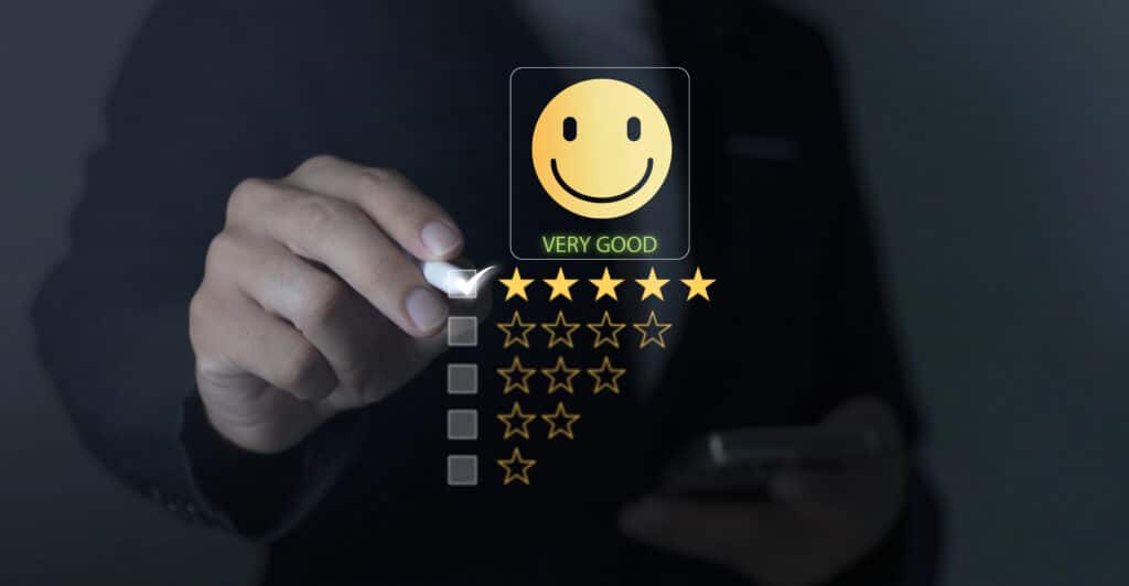 Hand giving 5-star rating with smiley face, indicating excellent service or product satisfaction.