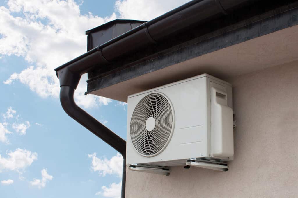 Outdoor air conditioner unit installed on building for efficient cooling.