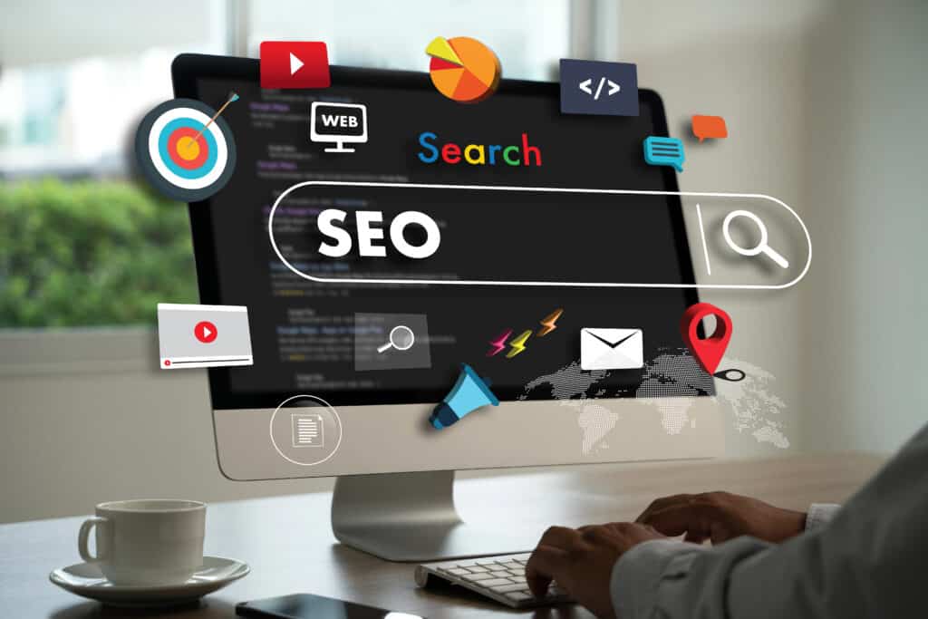 Computer screen with SEO search bar, icons, and user typing, representing digital marketing strategies.